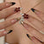 Kunstnagelset mit elegantem Blumen- und Glitzerakzent Brehn