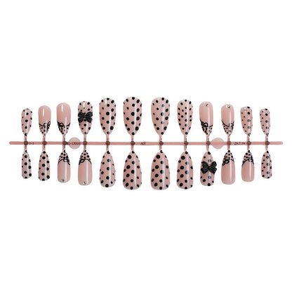 Kunstnagelset mit eleganten Punkte- und Schleifenmotiven Brehn