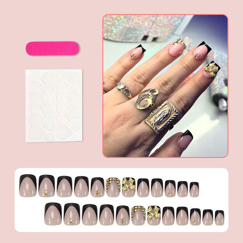 Kunstnagelset mit eleganten Schwarzspitzen und glitzernden Akzenten Brehn