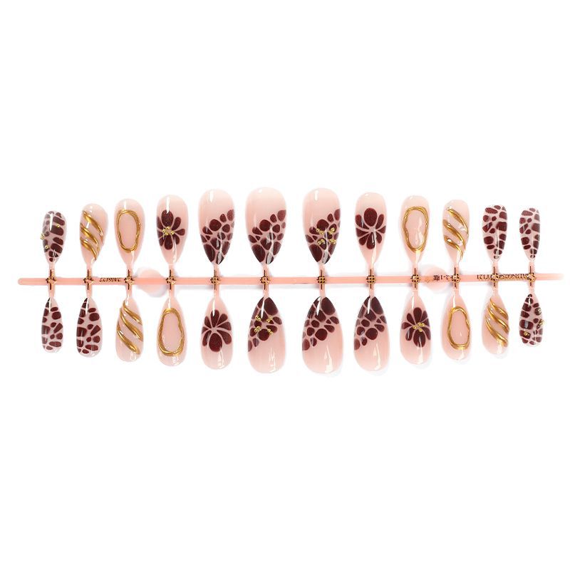 Kunstnagelset mit eleganten Blüten- und Goldakzenten Brehn