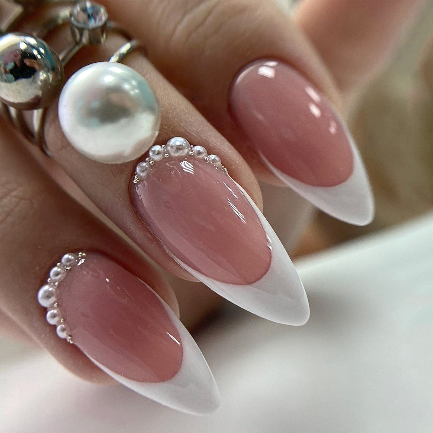 Kunstnagelset mit eleganter French Spitze und perlenverzierten Akzenten Brehn