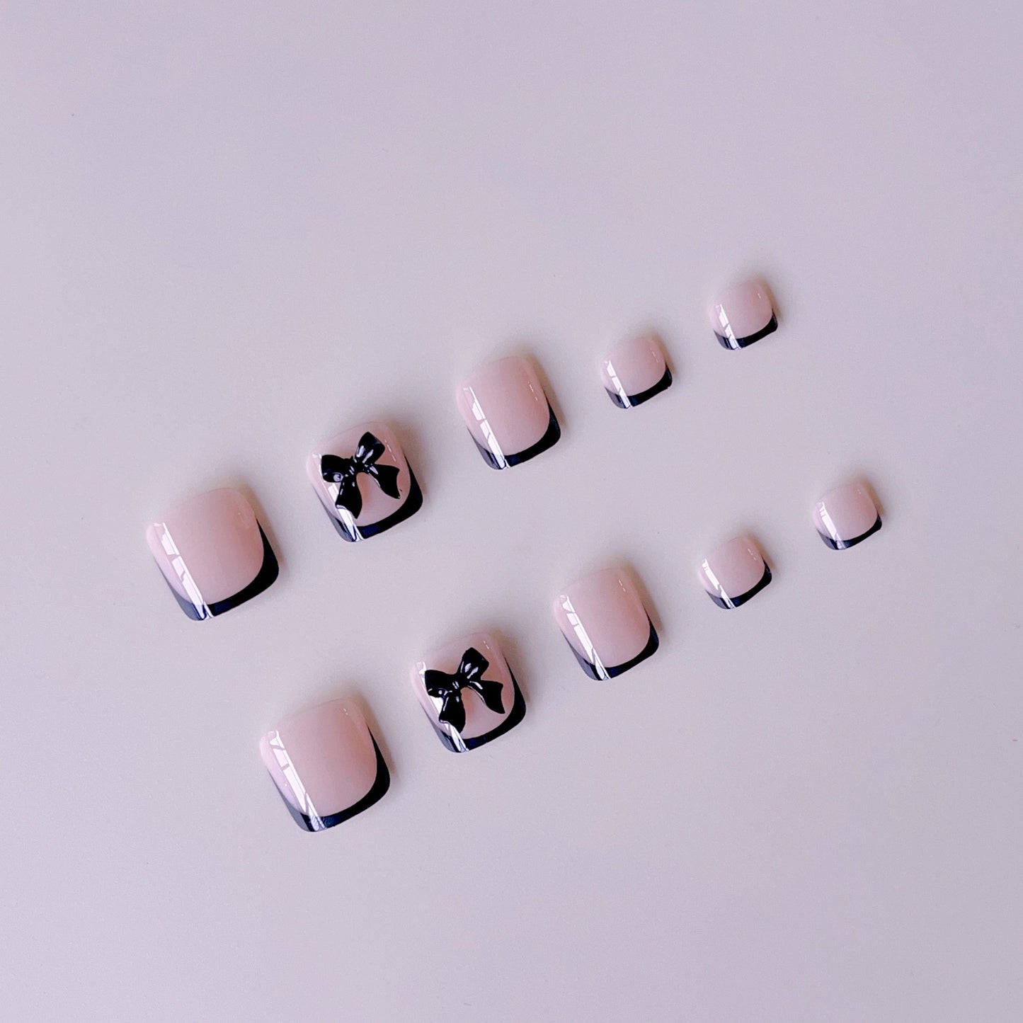Kunstnagelset mit eleganten Schleifenakzenten Brehn