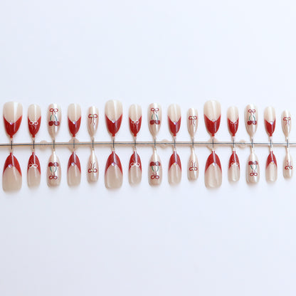 Künstlerisches Press-On-Nagelset mit Kirsch- und Schleifendessin Brehn