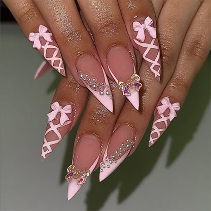 Kunstvolle Stiletto-Nägel mit Glitzer- und Schleifenverzierung Brehn