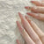 Kunstnagelset mit elegantem Ombre-Effekt und glamourösen Verzierungen Brehn