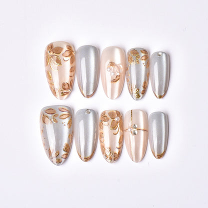 Dekoratives Press-On Nail Art Set mit floralen und metallischen Akzenten Brehn
