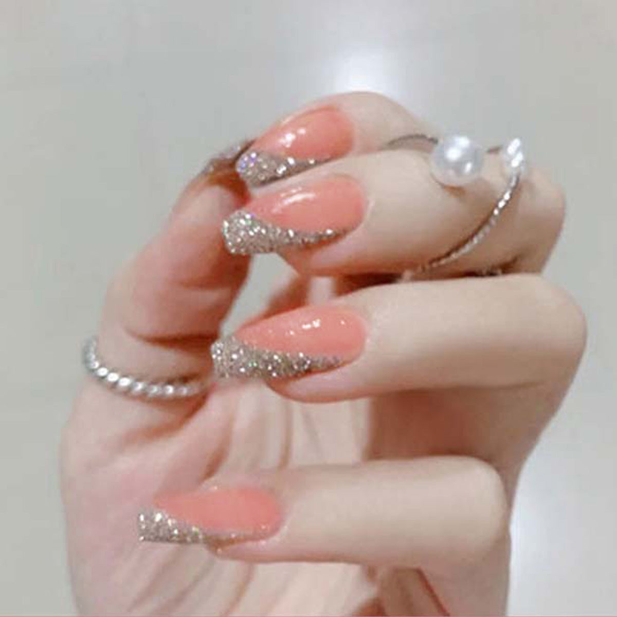 Glamouröses Kunstnagelset mit funkelnden Glitter- und French-Spitzen Brehn