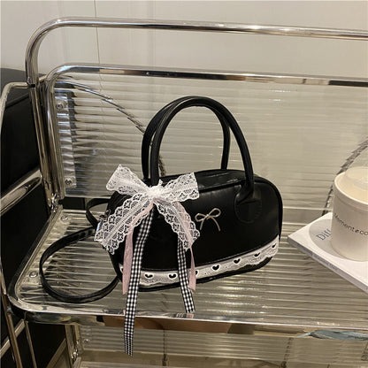 Elegante mit Spitzenbesatz verzierte Bogenhandtasche Brehn