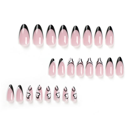 Kunstvolle Stiletto-Nägel mit elegantem Schwarz-Weiß-Design Brehn