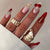 Dekorativer Kunst Press-On Nagelset mit Kirsch- und Goldakzenten Brehn