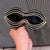 Damen Glamouröse Wellen-Sonnenbrille mit funkelnden Kristall-Applikationen Brehn