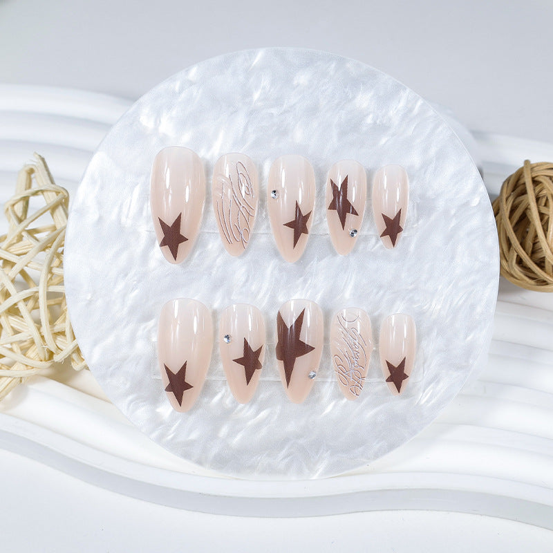 Kunstnagelset mit eleganten Sternenmotiven und Glitzerakzenten Brehn