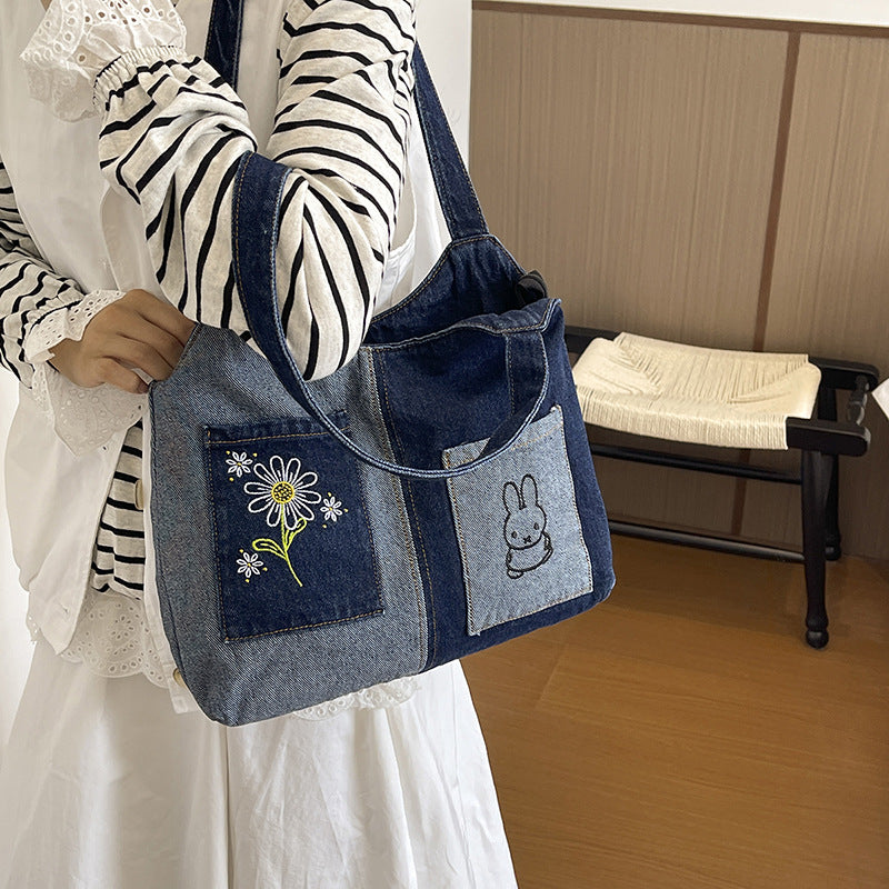 Künstlerisch bestickte Denim-Handtasche