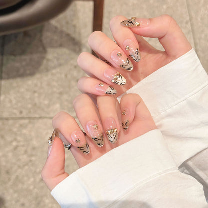 Künstlerisches Press-On Nagelkunst Set mit luxuriösen Gold- und Schwarzmotiven