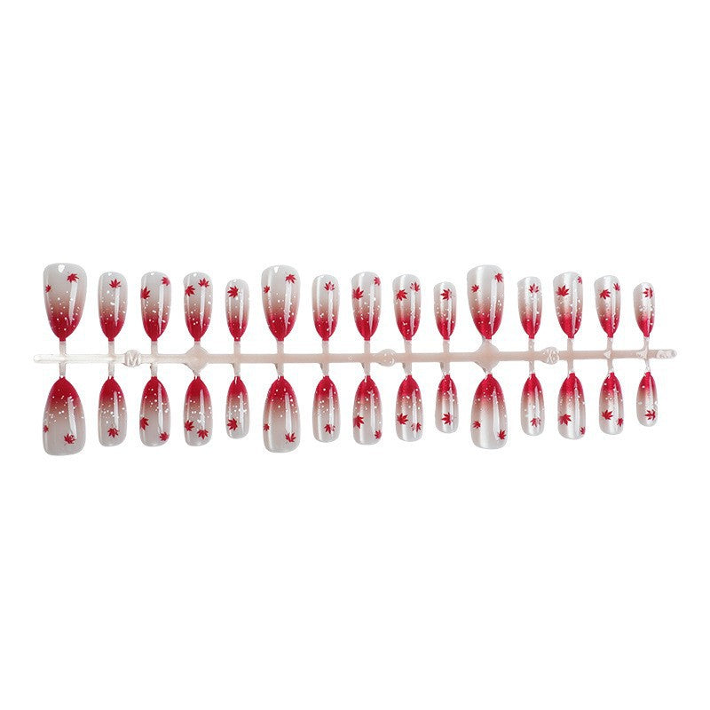 Kunstnagelset mit elegantem Rot-Ombré-Look und zarten Ahornblättern Brehn