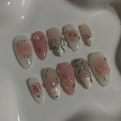Kunstvolle Nagelspitzen mit Glitzer- und Schleifenmotiven Brehn