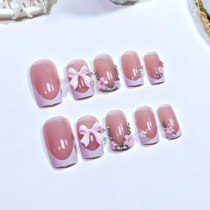 Kunstnagelset mit verspielten Schleifen und eleganten Blütenverzierungen Brehn