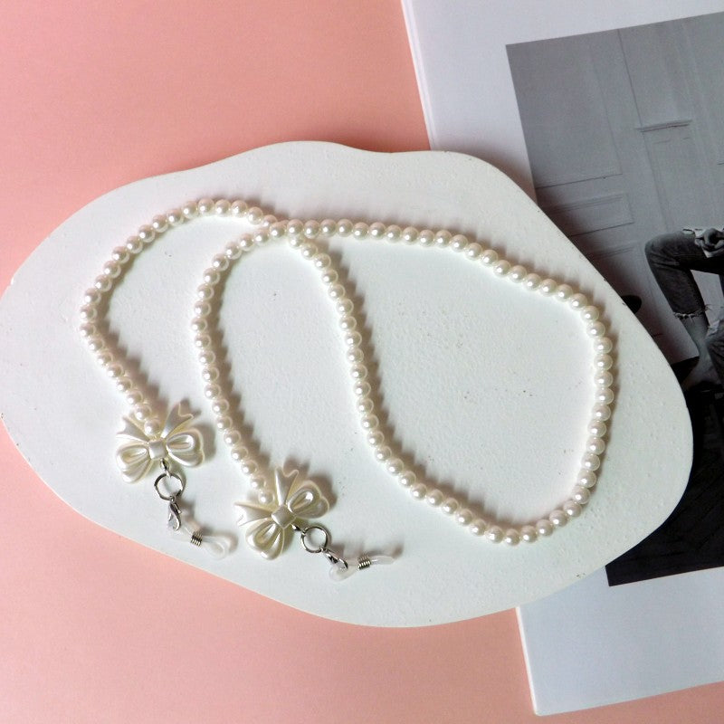 Elegante Perlen-Brillenkette mit Schleifenanhängern Brehn
