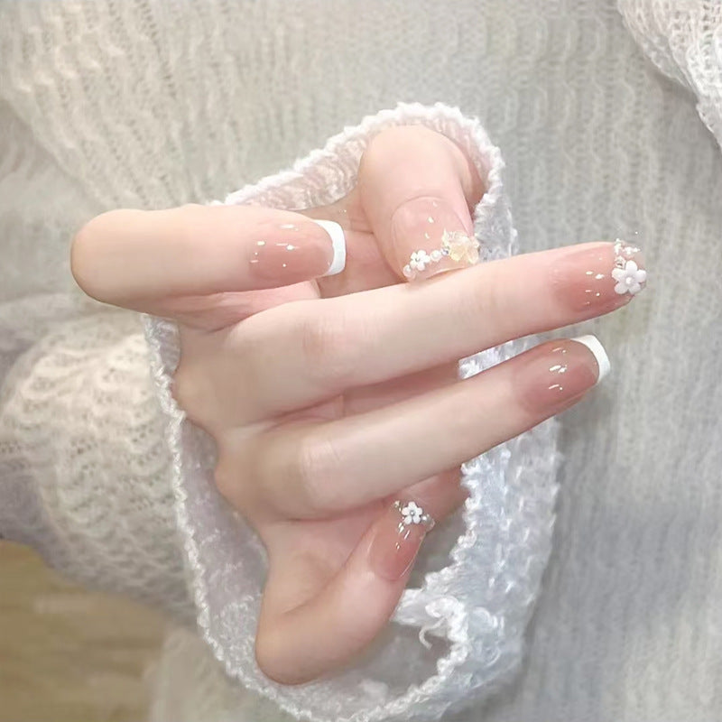 Kunstnagelset mit eleganten Blumenapplikationen und exquisite Glitzerverzierungen Brehn