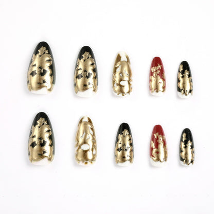 Elegante Kunstnägel mit Gold- und Schwarzmuster Brehn