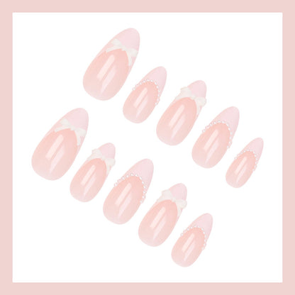 Kunstnagelset mit eleganten Schleifen und Spitzen Brehn
