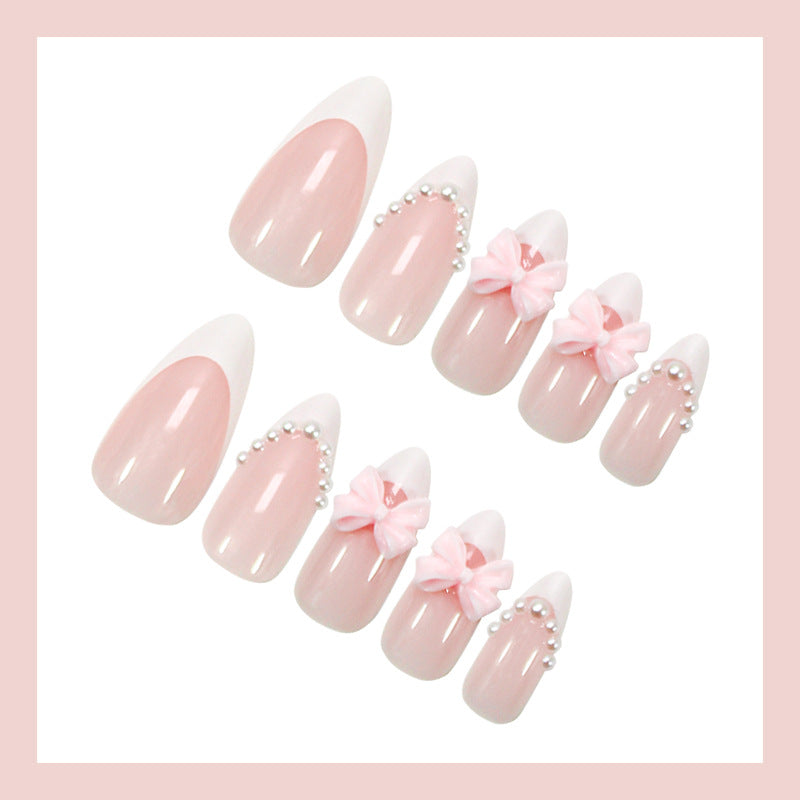 Kunstnagelset mit eleganten Schleifen- und Perlenverzierungen Brehn