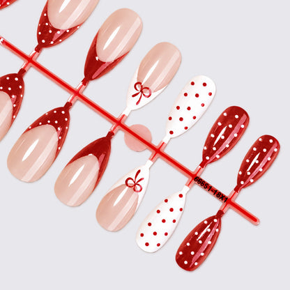 Kunstnagelset mit eleganten Schleifen- und Punkten Brehn