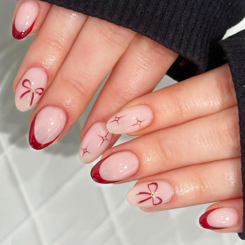 Kunstnagelset mit elegantem Bogen-Design und Glitzereffekten Brehn