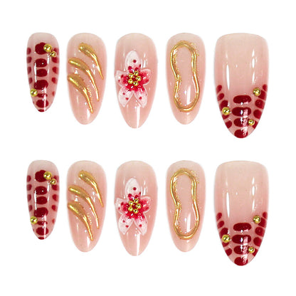 Kreatives Kunstnagelset mit floralen Verzierungen und glamourösen Akzenten Brehn
