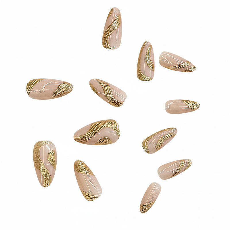 Künstlerisches Press-On Nagelset mit goldener Wirbel-Design Brehn