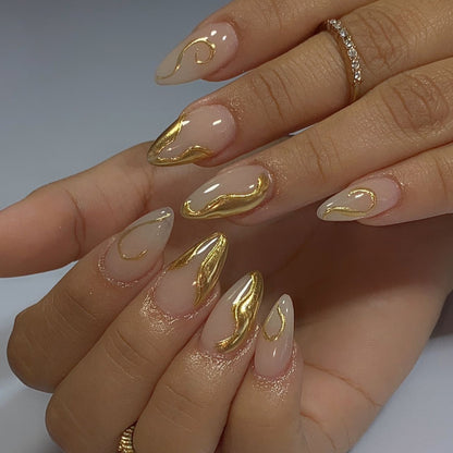 Kunstvolle Stiletto-Nägel mit eleganten Goldakzenten Brehn