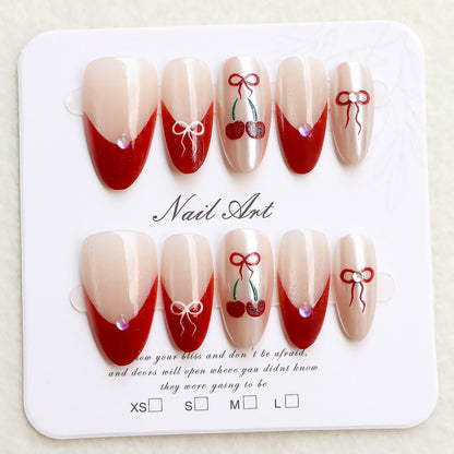 Künstlerisches Press-On-Nagelset mit Kirsch- und Schleifendessin Brehn