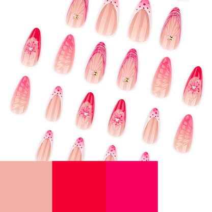 Kunstvolle Stiletto-Nägel mit floralem Design und Glitzerakzenten Brehn