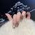 Dekoratives Press-On-Nageldesign mit Edelsteinakzenten Brehn