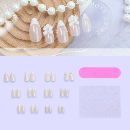 Kreatives Kunstnagelset mit eleganten Schleifen und Perlenelementen Brehn