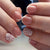 Kunstnagelset mit elegantem French Design und floralen Akzenten Brehn