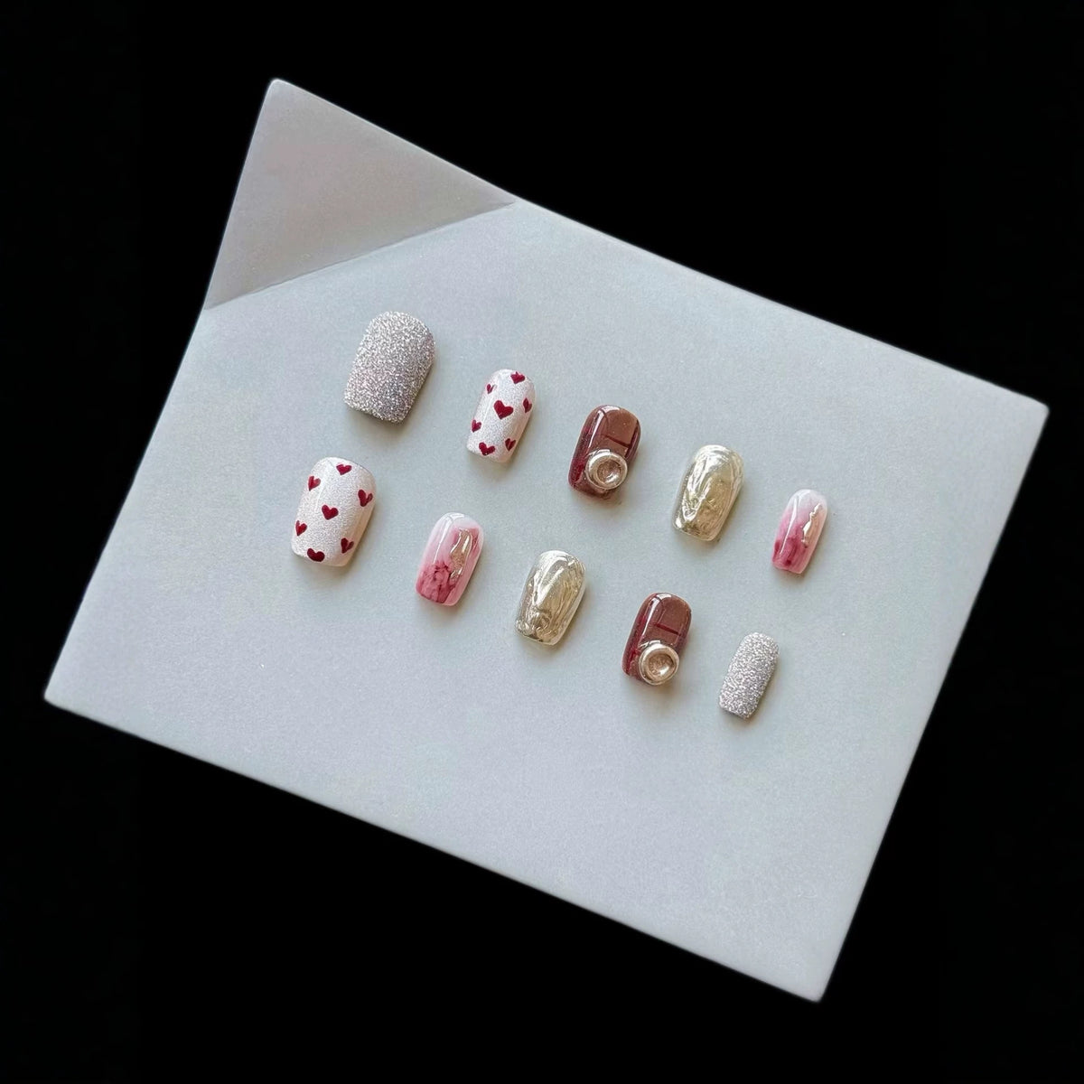 Künstlerisches Press-On-Nagelset mit Herz- und Glitzerelementen