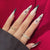 Lange Stiletto Press-On Nagelkunst mit Schneeflocken-Design Brehn