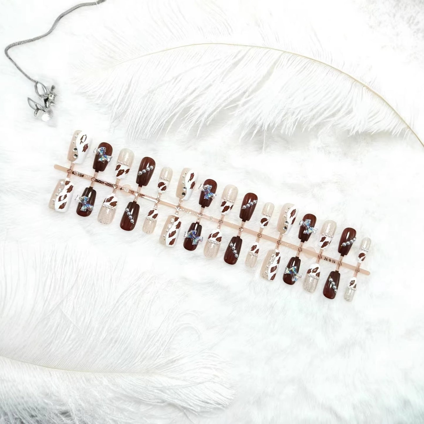 Kunstnägel mit funkelnden Strass- und Schleifenakzenten Brehn