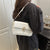 Vielseitige strukturierte Crossbody-Handtasche Brehn