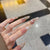 Dekoratives Stiletto Press-On Nagelkunst-Set mit Schneeflocken- und Edelsteinakzenten Brehn