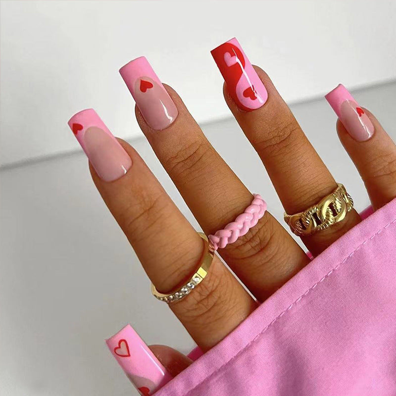Künstliche Nagelkunst mit Herz-Design und Glitzerakzenten Brehn
