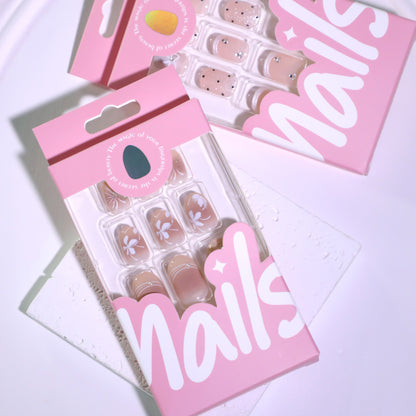 Kunstvolle Nagelgestaltung mit floralem Design und Glitzerakzenten Brehn
