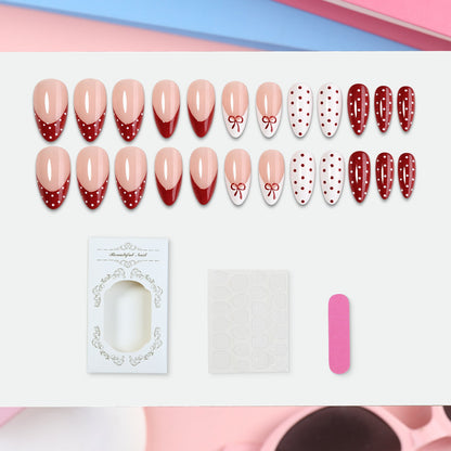 Kunstnagelset mit eleganten Schleifen- und Punkten Brehn