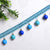 Dekorativer Spitzenbesatz mit Bunten Anhängern Brehn