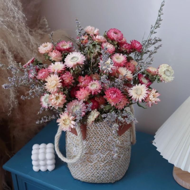 Elegantes künstliches Blumenarrangement im geflochtenen Korb