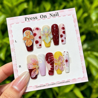 Künstlerisches Press-On Nagelset mit floralen und gemusterten Designs