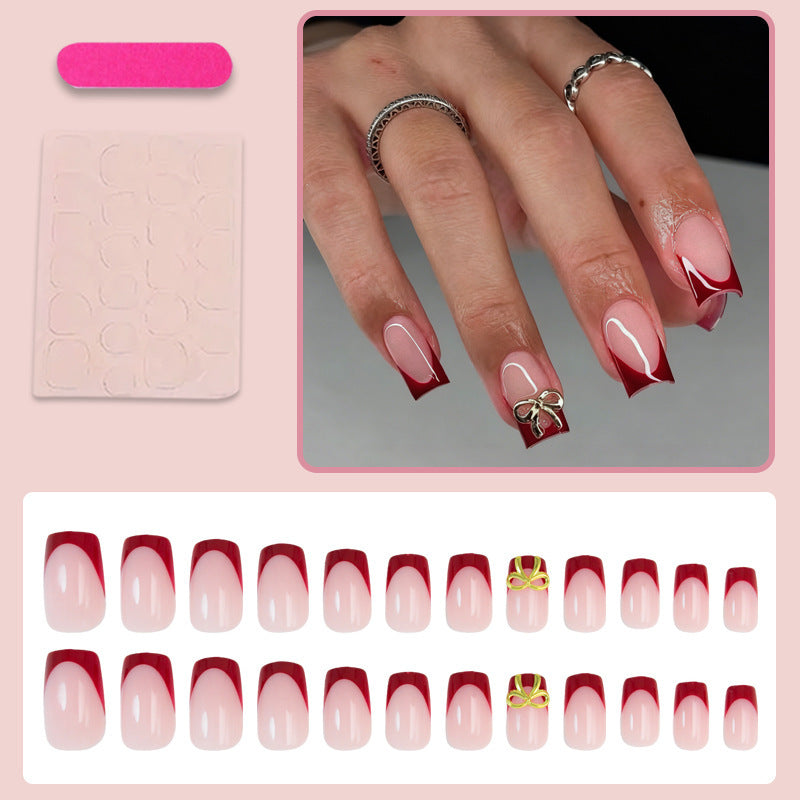 Kunstnagelset mit eleganten roten Spitzen und raffinierten Schleifenverzierungen Brehn