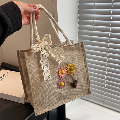 Blumennietete Jute-Handtasche