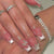 Kunstnagelset mit filigranen Designs und Schmetterlingsapplikationen Brehn